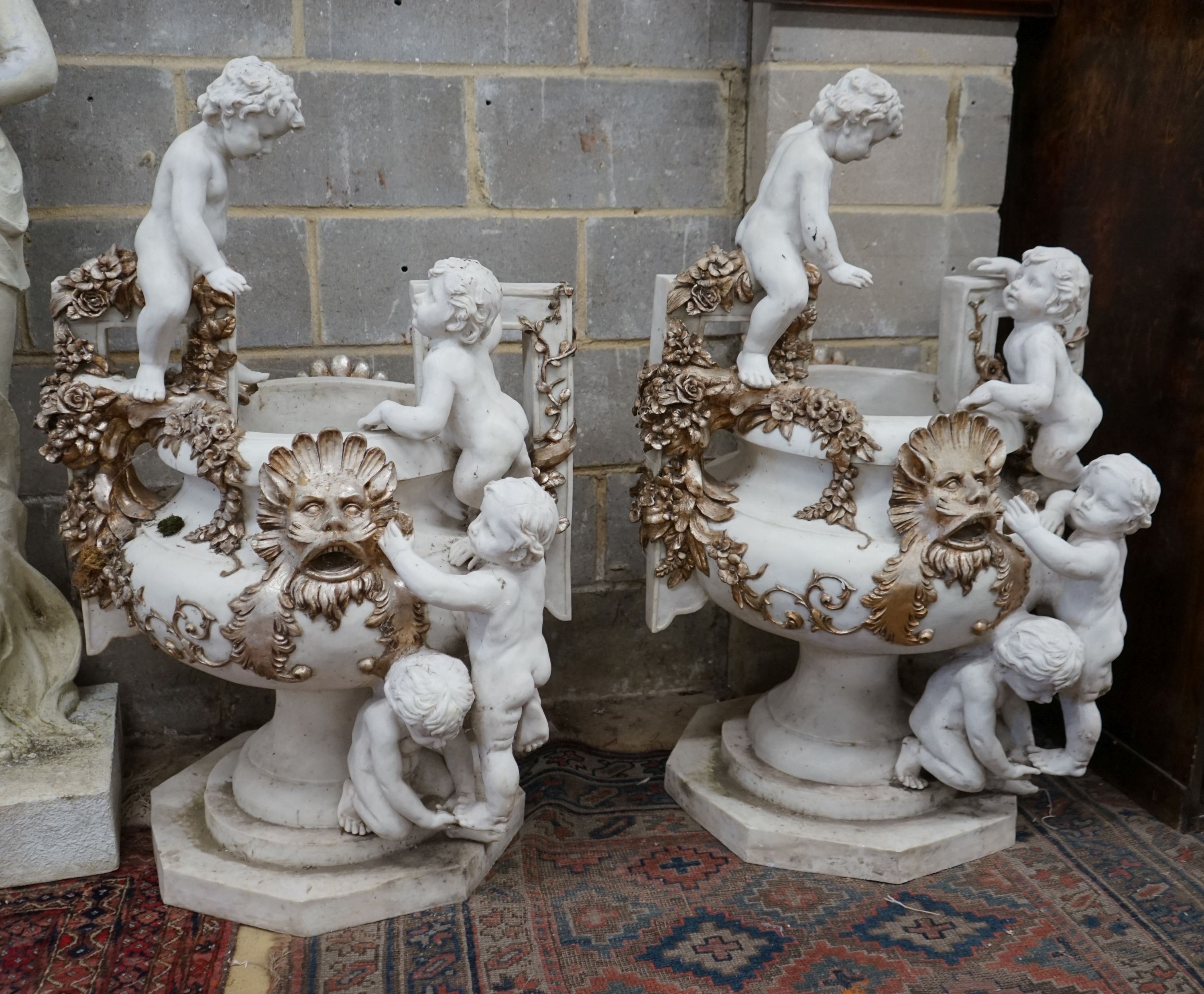 A pair of composition faux marble cherub and mask jardinieres, height 112cm